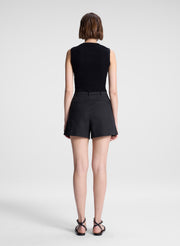 woman wearing black sleeveless top and black linen shorts