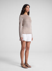 woman wearing tan sweater and white shorts