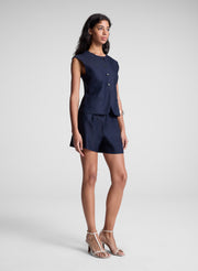 woman wearing navy blue vest and matching shorts