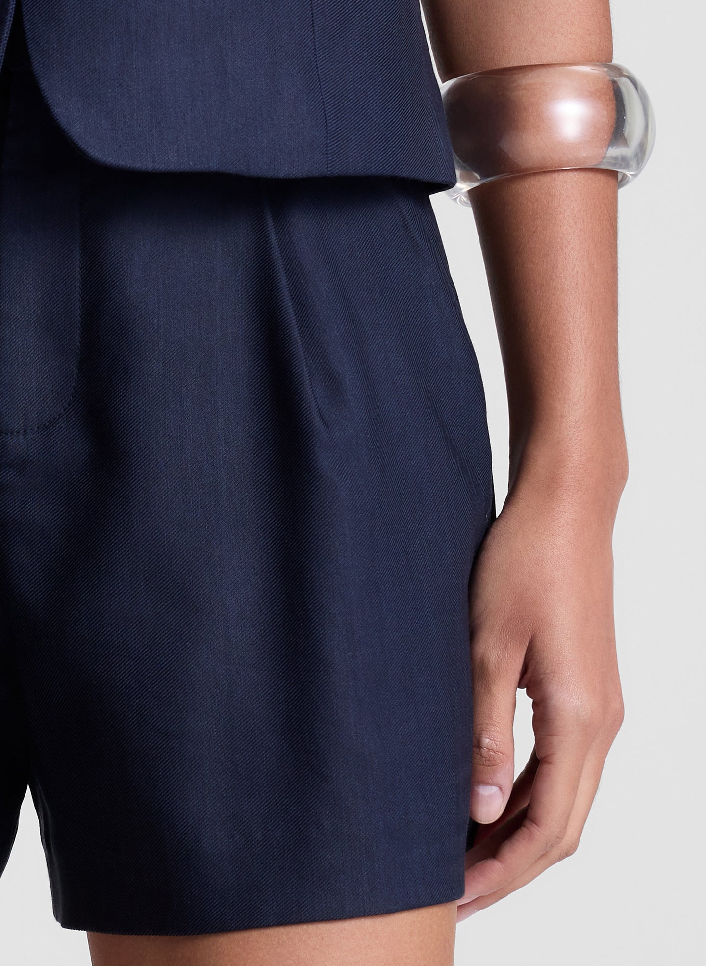 woman wearing navy blue vest and matching shorts