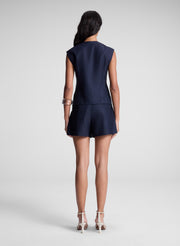 woman wearing navy blue vest and matching shorts