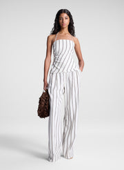 woman wearing striped halter top and matching striped pant set