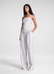 woman wearing striped halter top and matching striped pant set