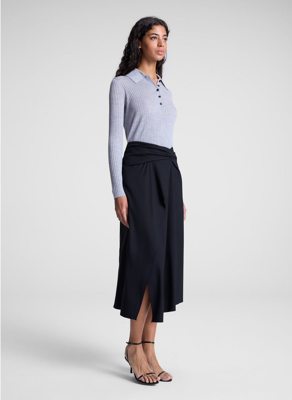 woman wearing grey collared top and black midi skirt