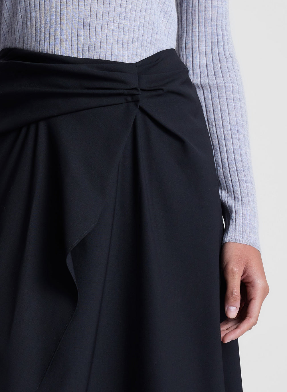 woman wearing grey collared top and black midi skirt