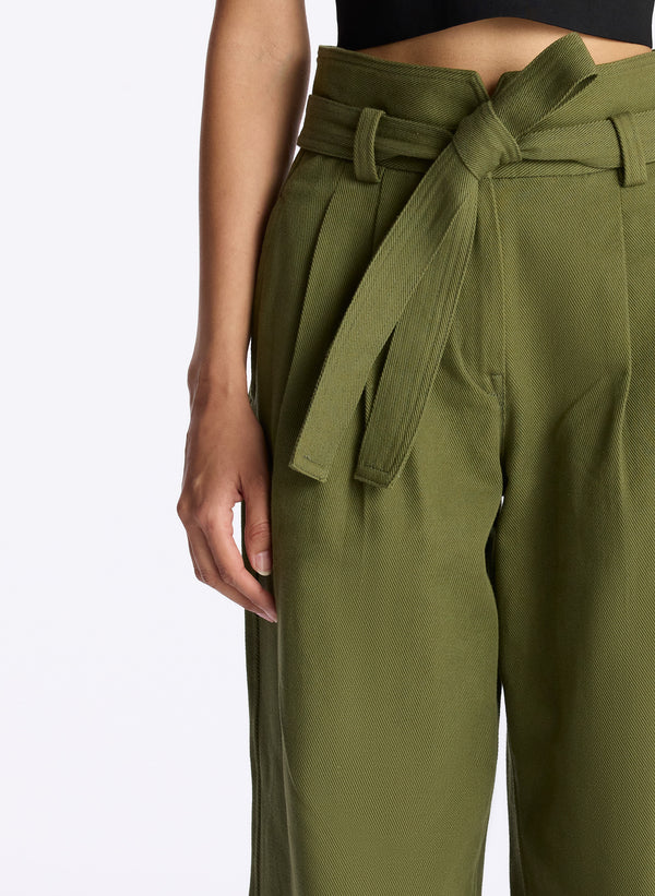 detail view of woman wearing black tank top and olive green wide leg pants
