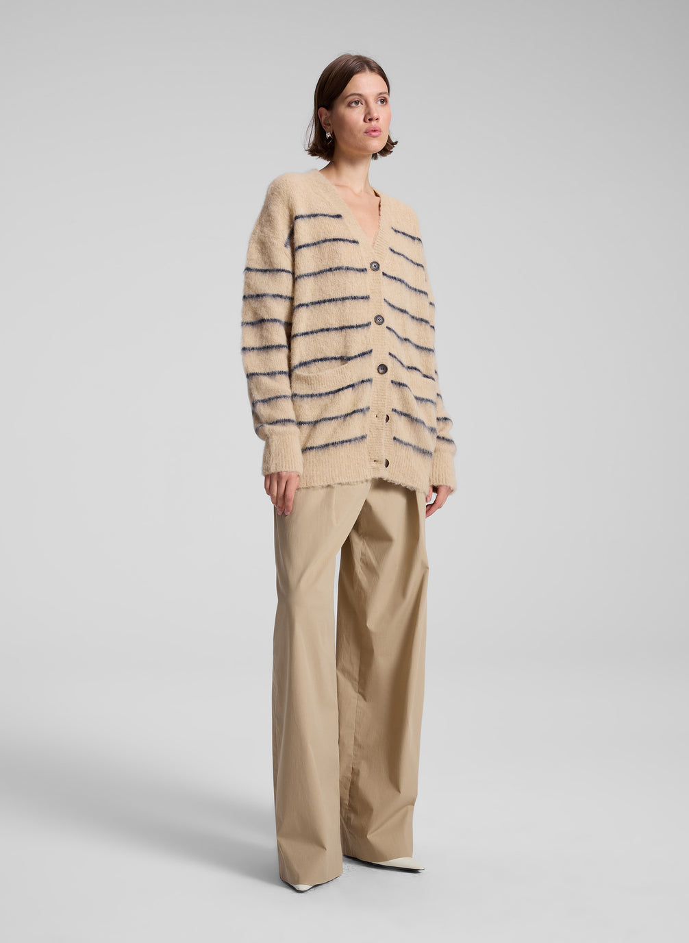 woman wearing tan striped cardigan and tan wide leg pants