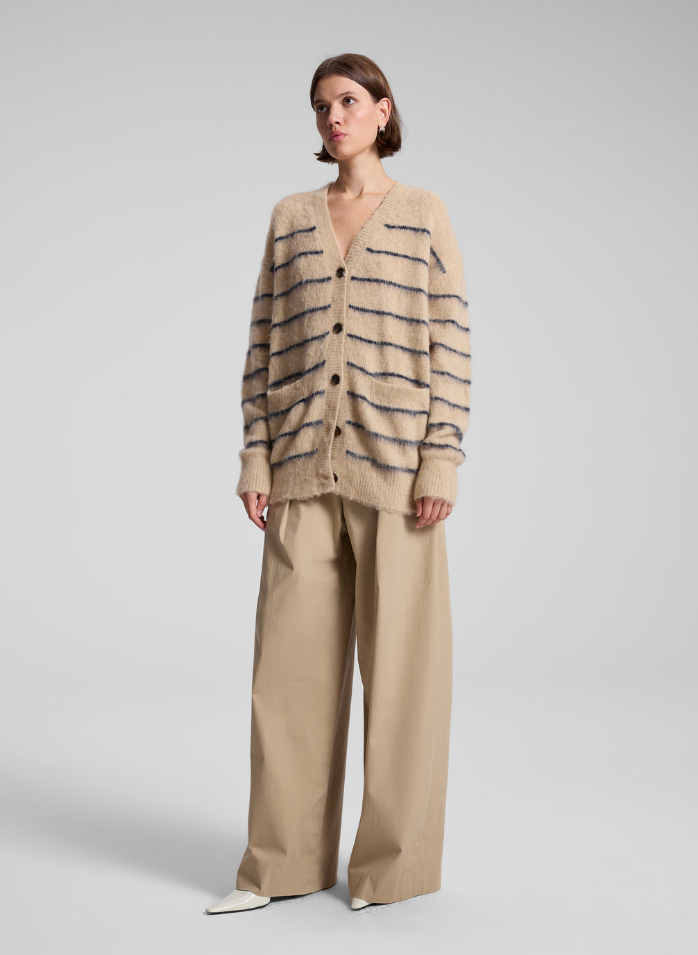 woman wearing tan striped cardigan and tan wide leg pants