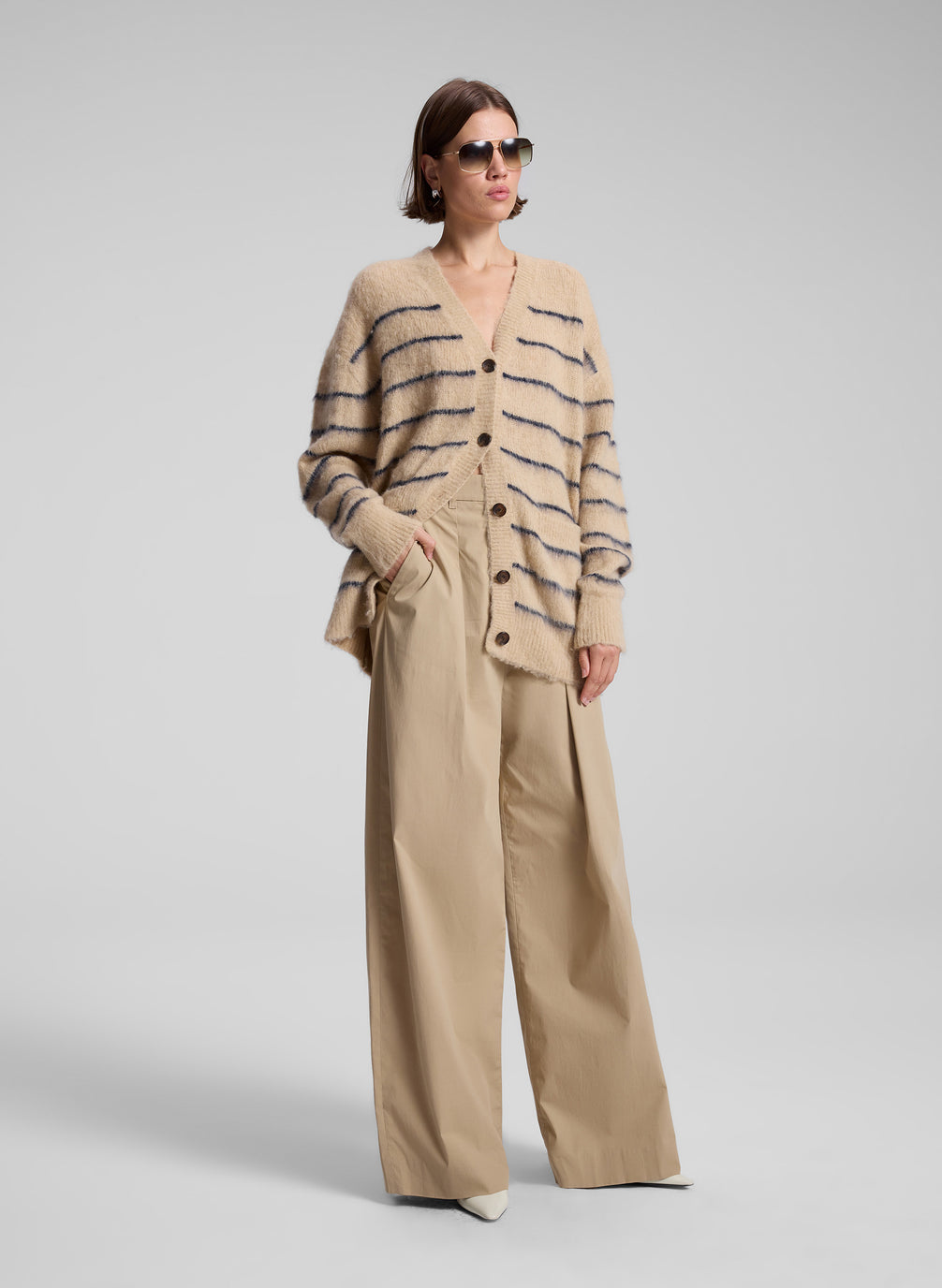 woman wearing tan striped cardigan and tan wide leg pants