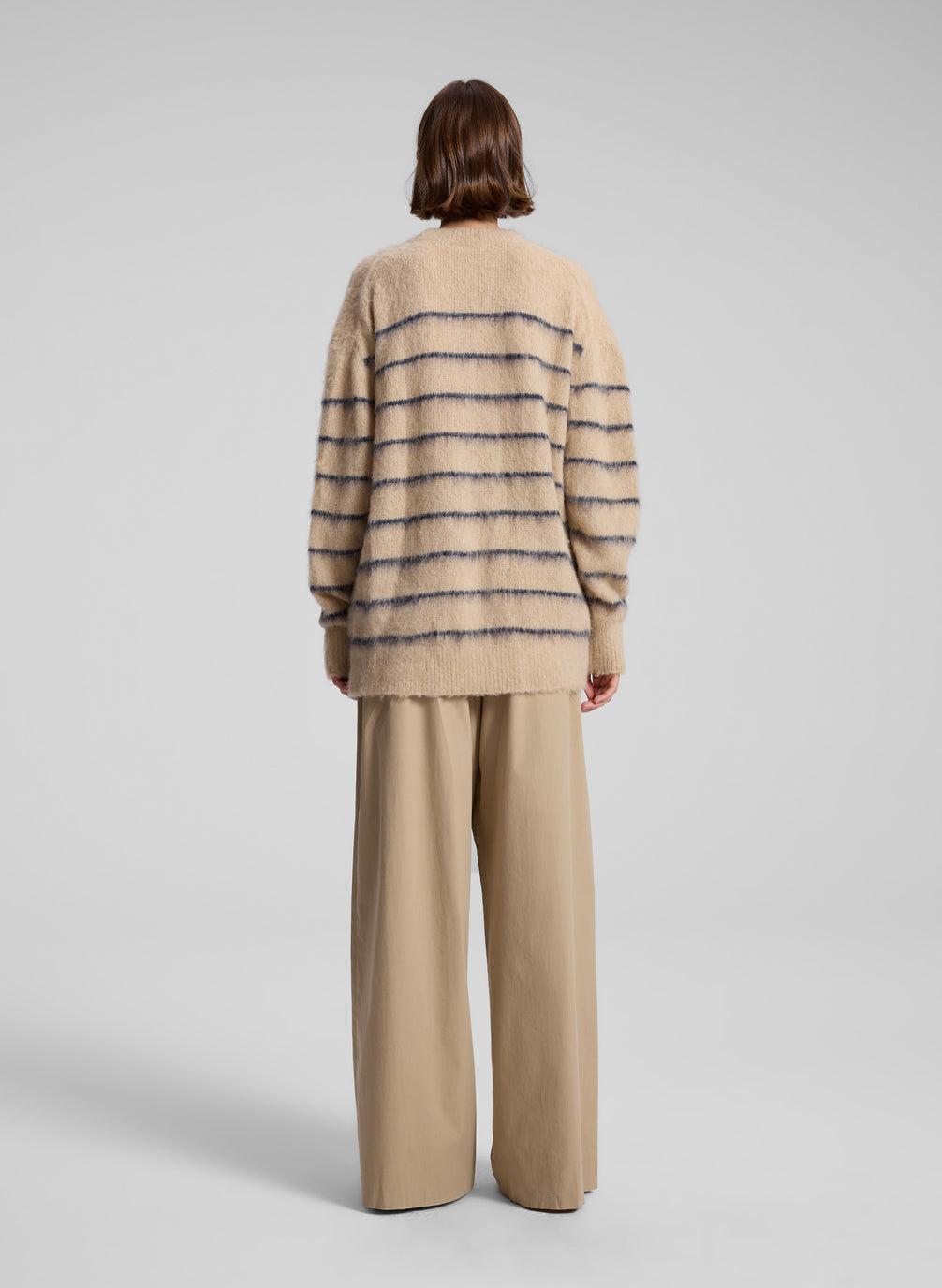 woman wearing tan striped cardigan and tan wide leg pants