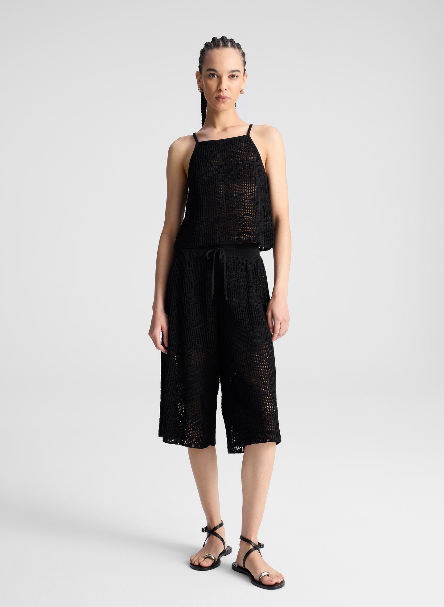 woman wearing  black crochet knit tank and matching short