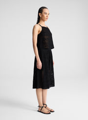 woman wearing  black crochet knit tank and matching short