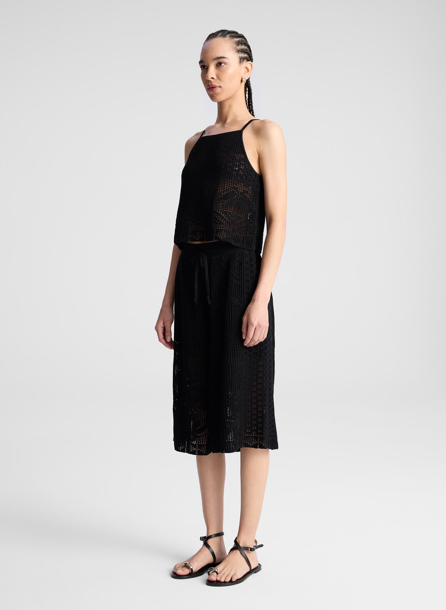 woman wearing  black crochet knit tank and matching short