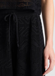 woman wearing  black crochet knit tank and matching short