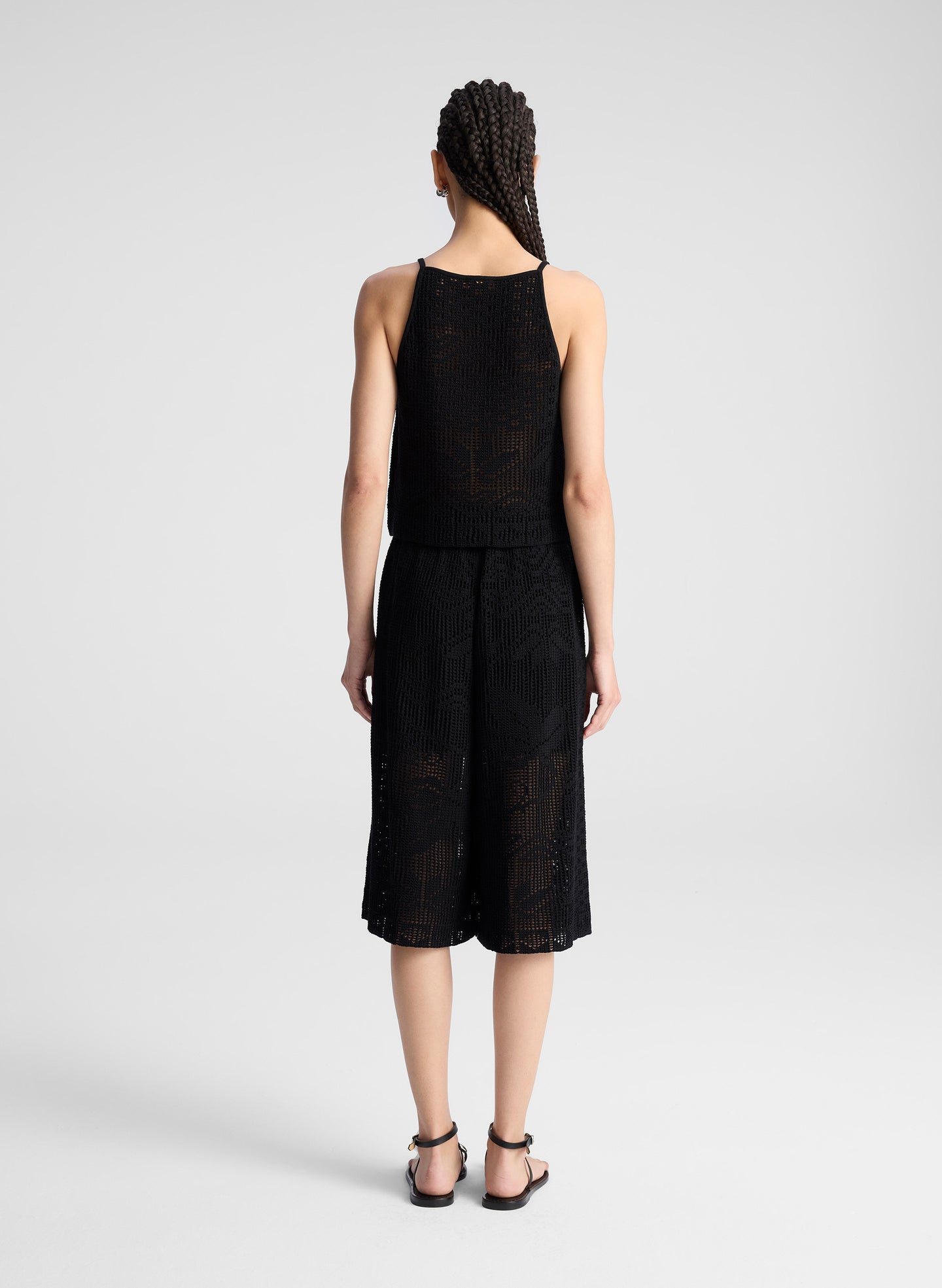 woman wearing  black crochet knit tank and matching short