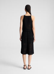 woman wearing  black crochet knit tank and matching short