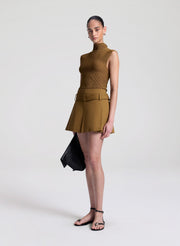 woman wearing brown knit top and brown skort