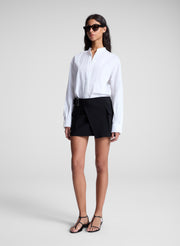 woman wearing white top and black mini skirt