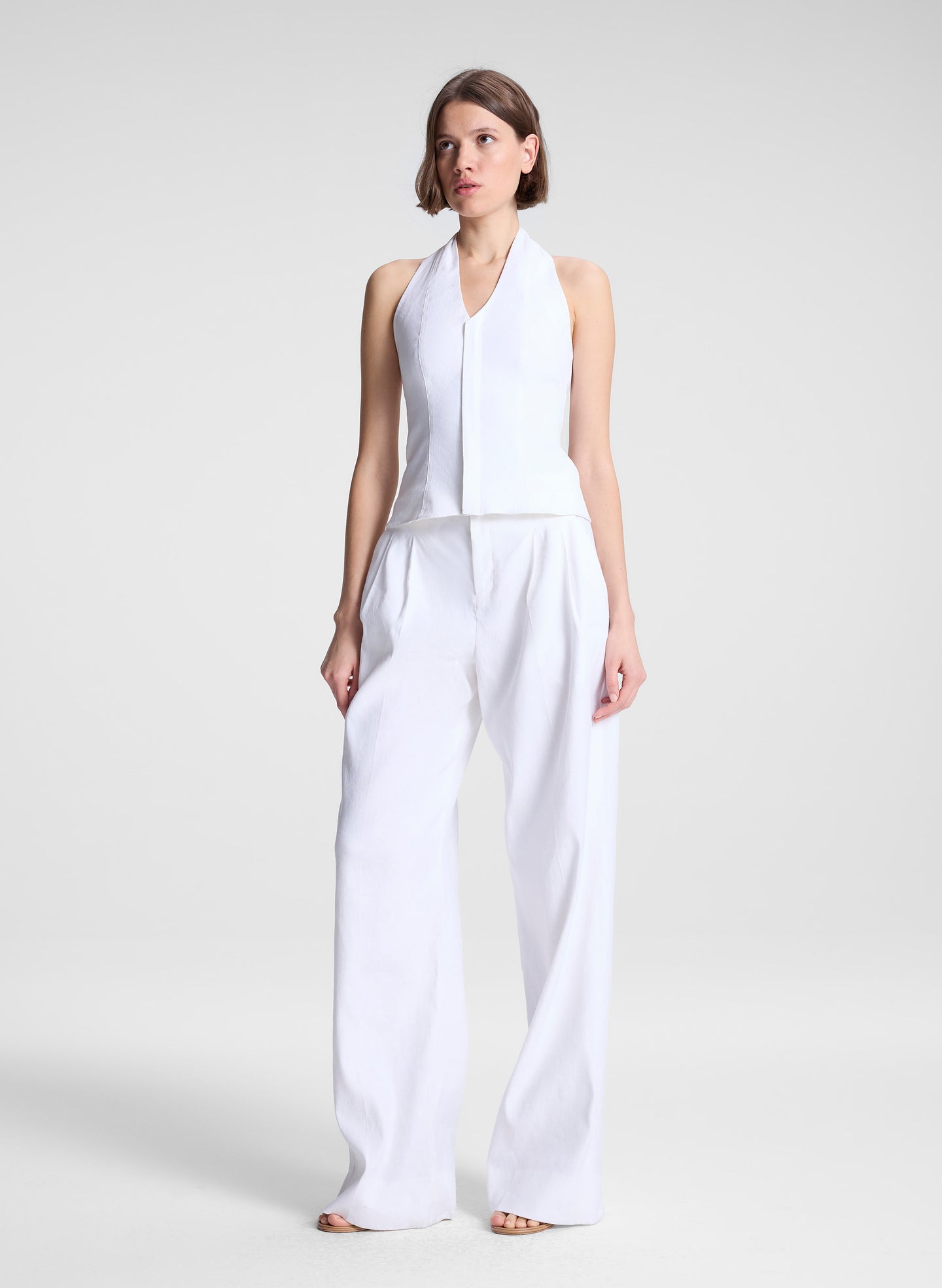 woman wearing white linen halter top and white linen pants