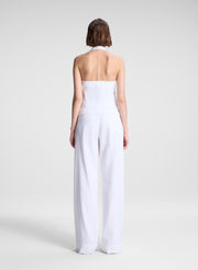 woman wearing white linen halter top and white linen pants