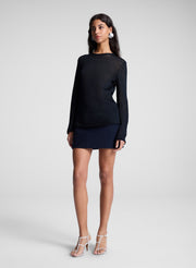 woman wearing navy blue sweater and navy blue mini skirt