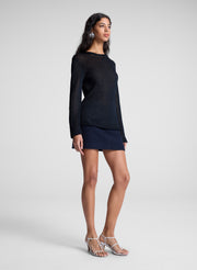 woman wearing navy blue sweater and navy blue mini skirt