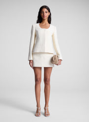 image of woman holding beige clutch bag