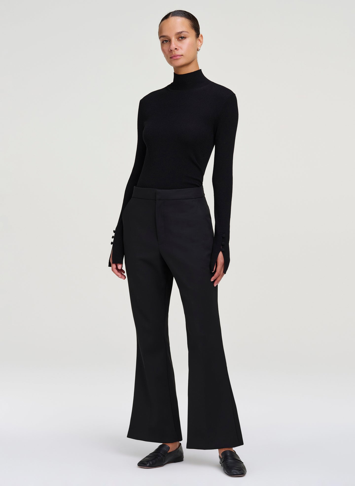 woman wearing black long sleeve top and black cropped pants
