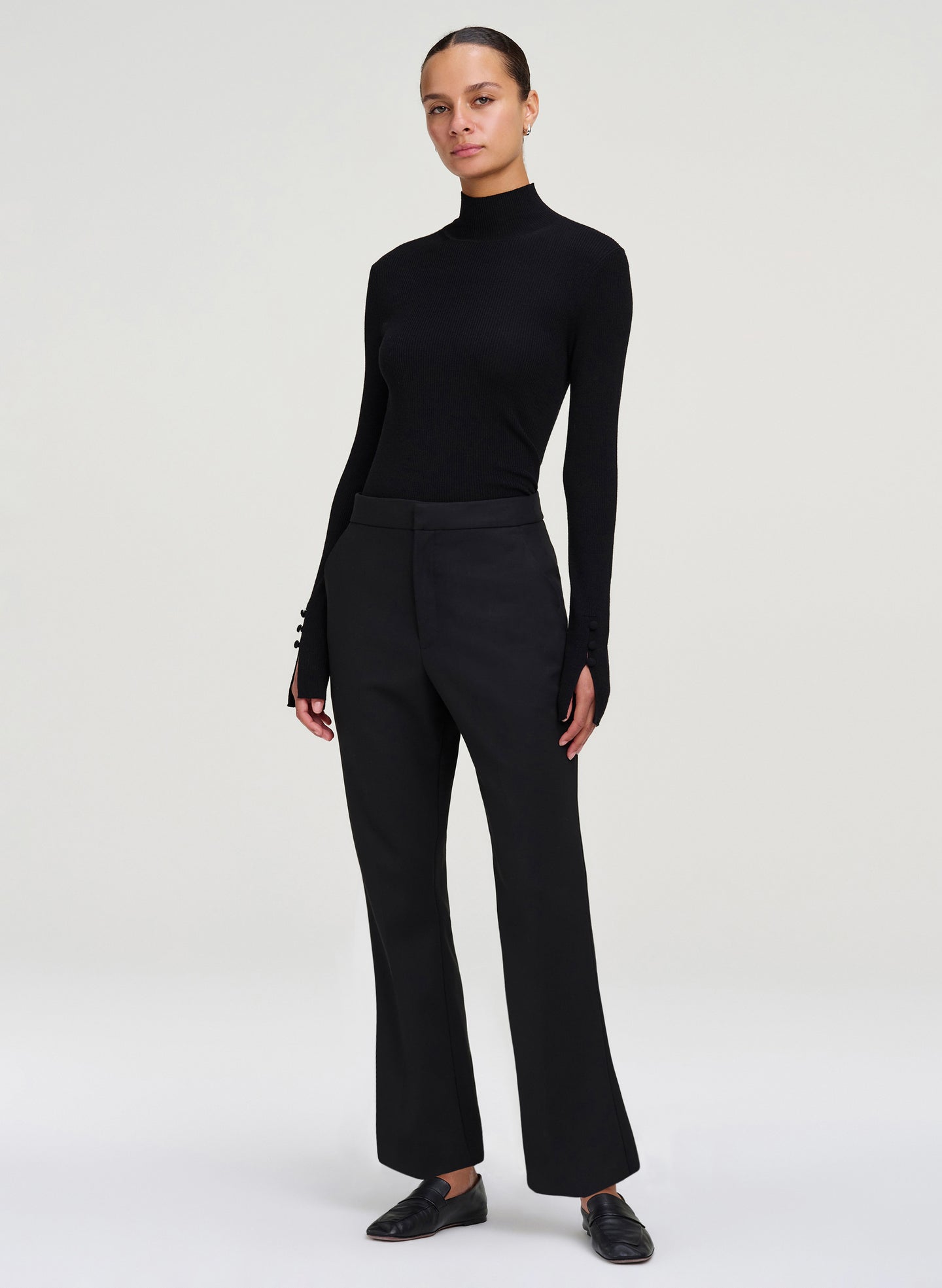 woman wearing black mock neck top and black cropped pants