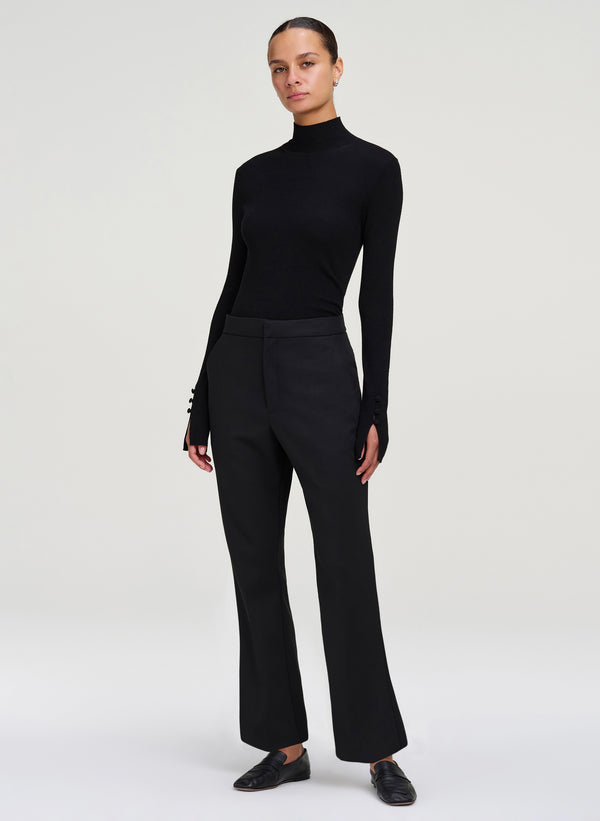 woman wearing black mock neck top and black cropped pants
