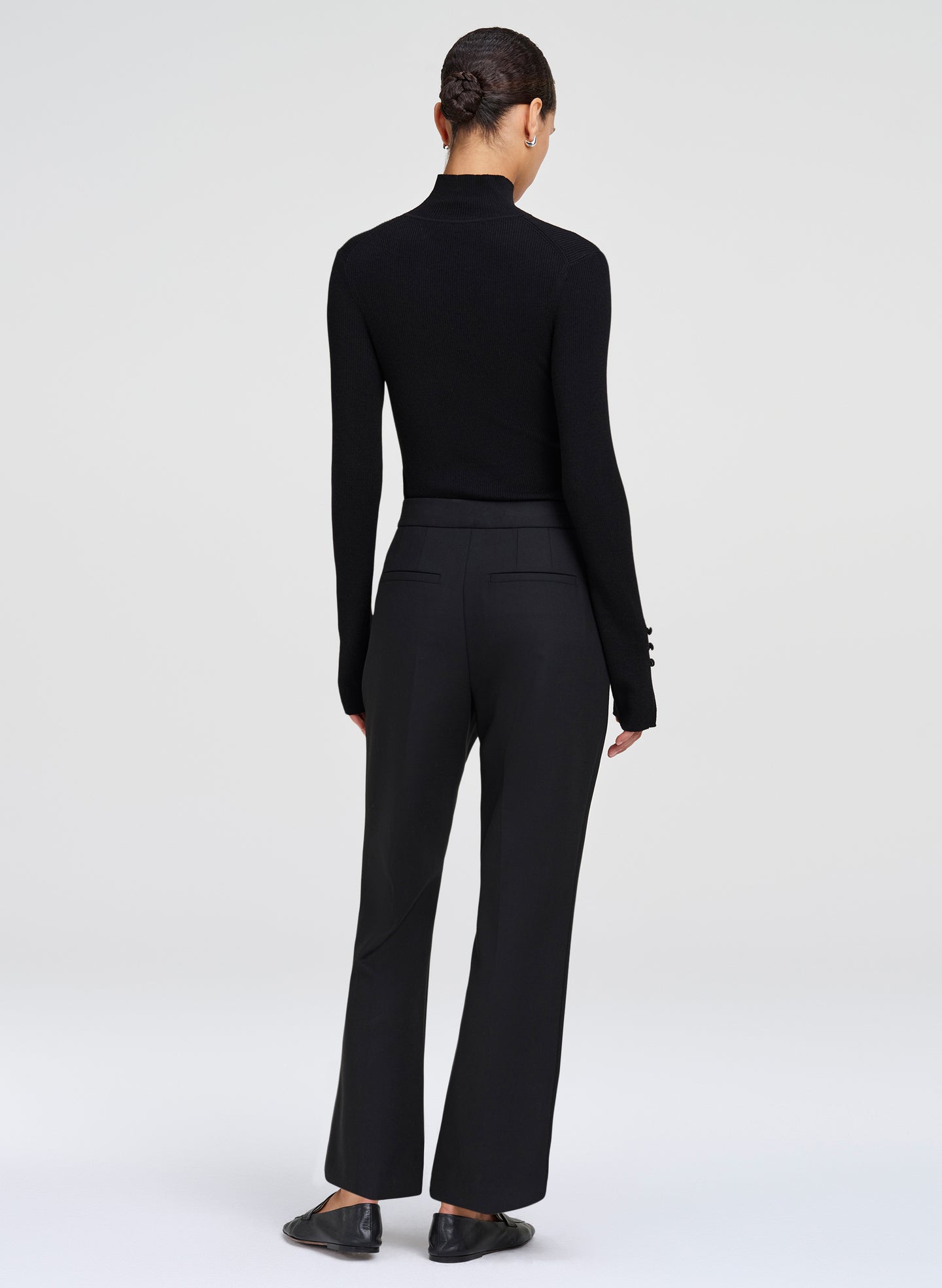 woman wearing black top and black trousers