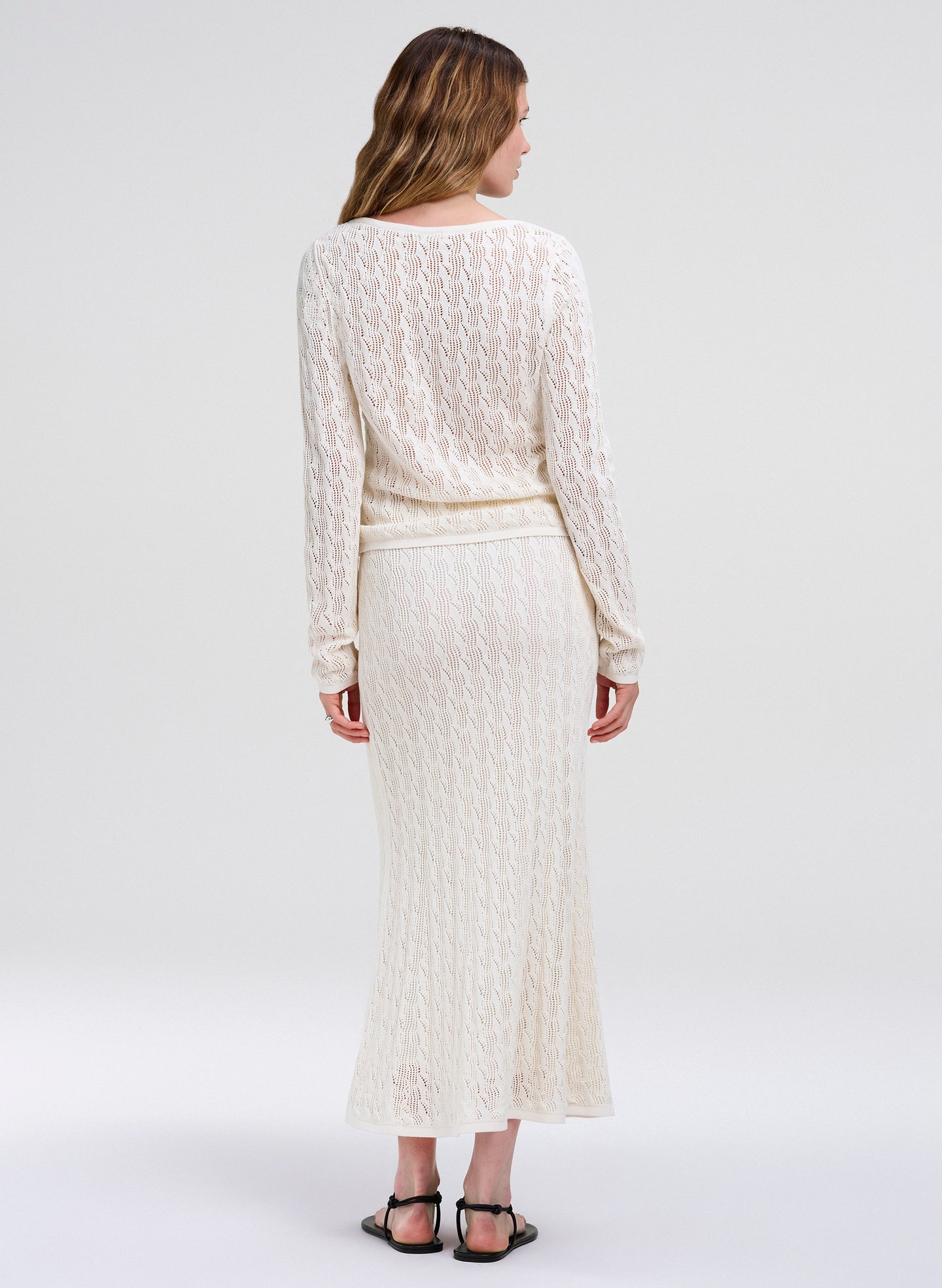 woman in cream knit outfit