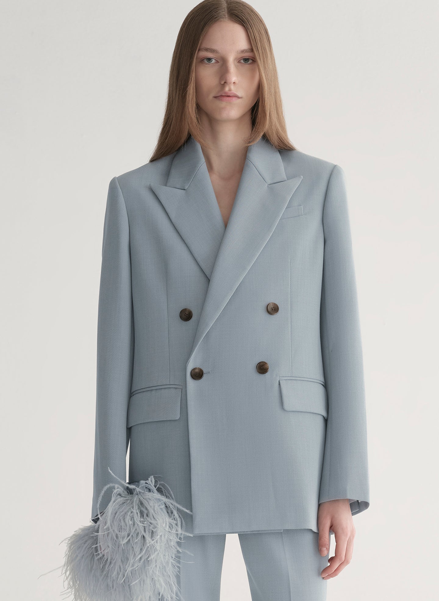 woman wearing light blue oversized suit