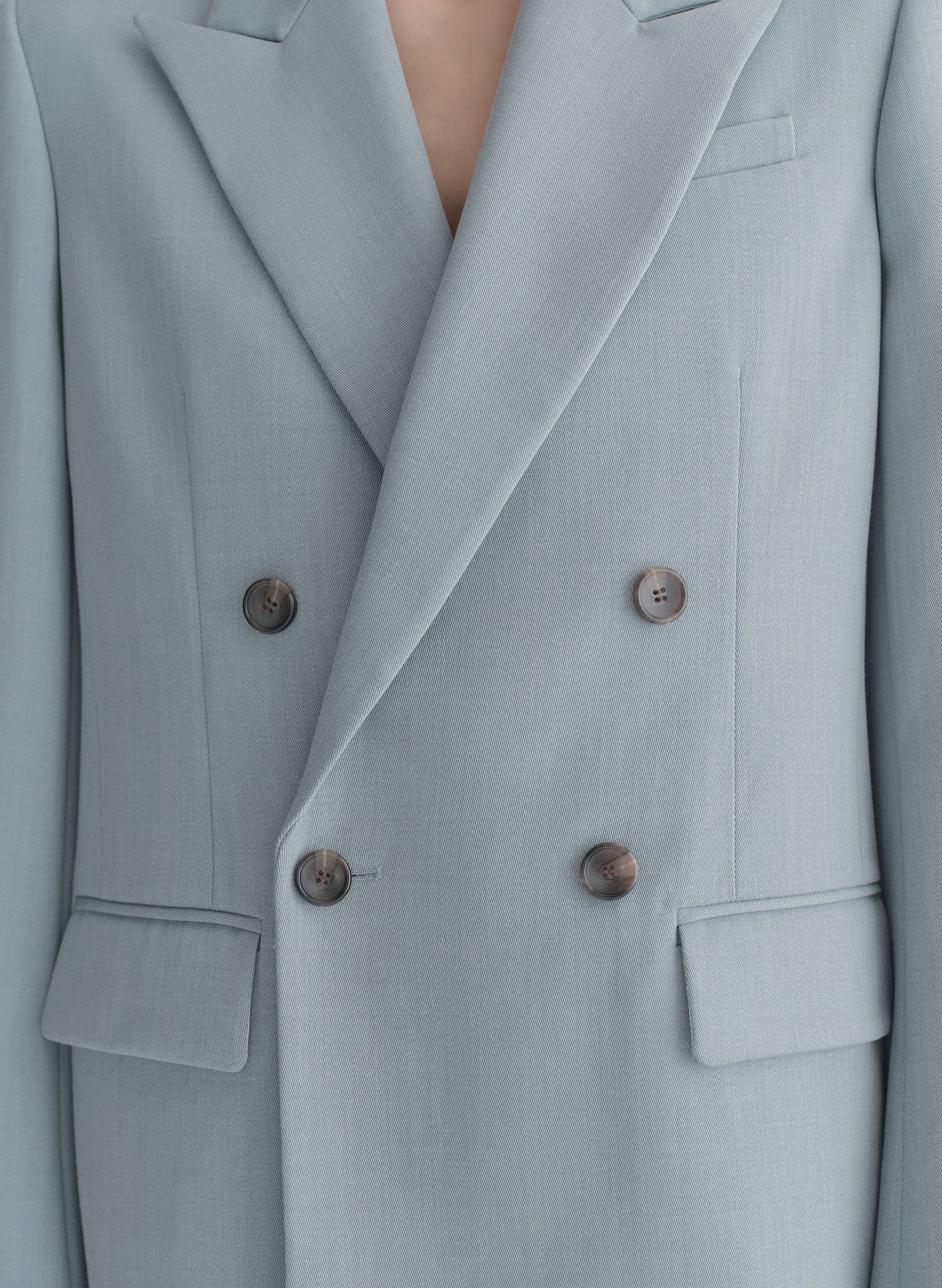 woman wearing light blue oversized suit