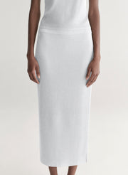 woman wearing silver one shoulder top and matching midi skirt