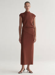 woman wearing rust knit top and skirt set