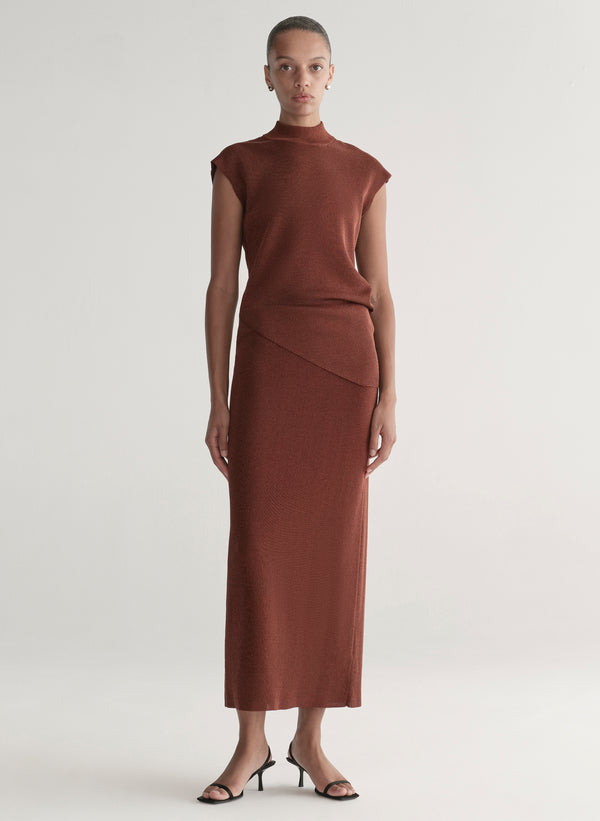 woman wearing rust knit top and skirt set