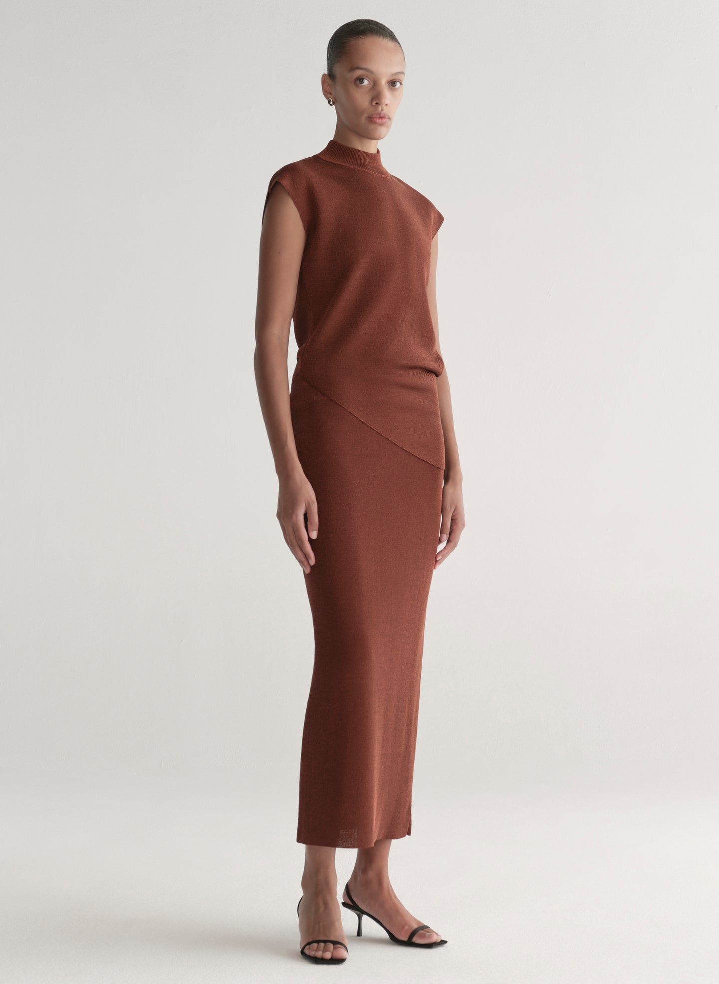 woman wearing rust knit top and skirt set