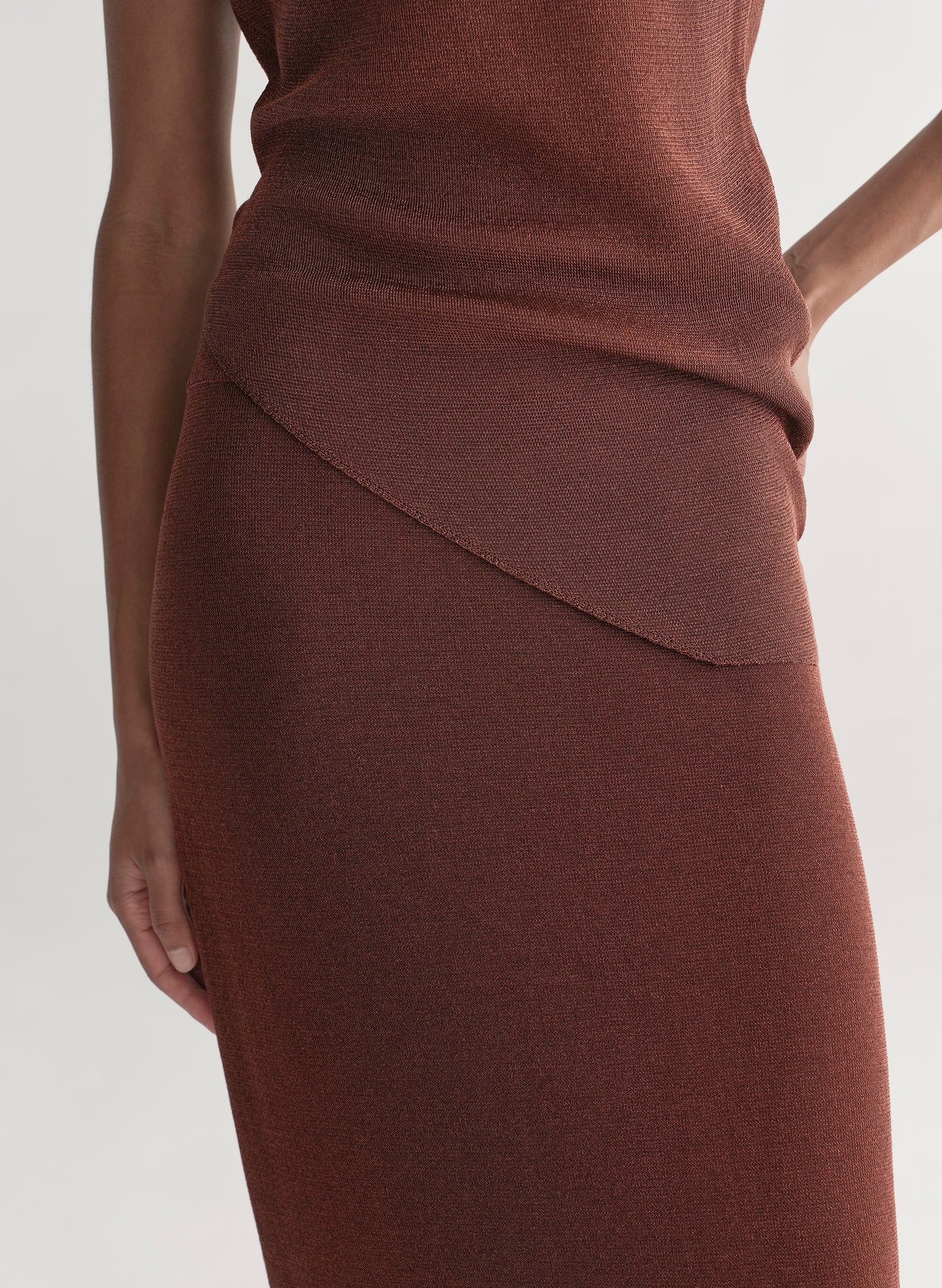 woman wearing rust knit top and skirt set