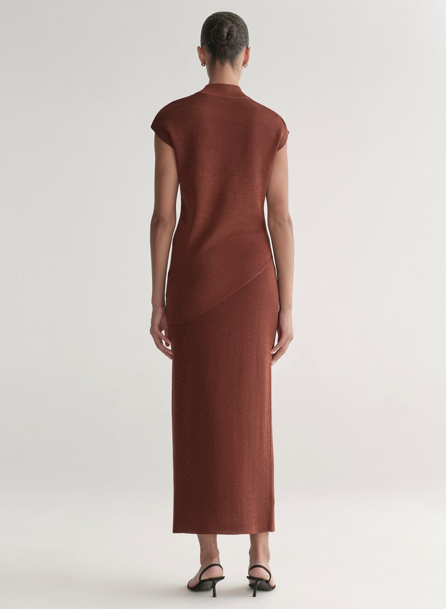 woman wearing rust knit top and skirt set