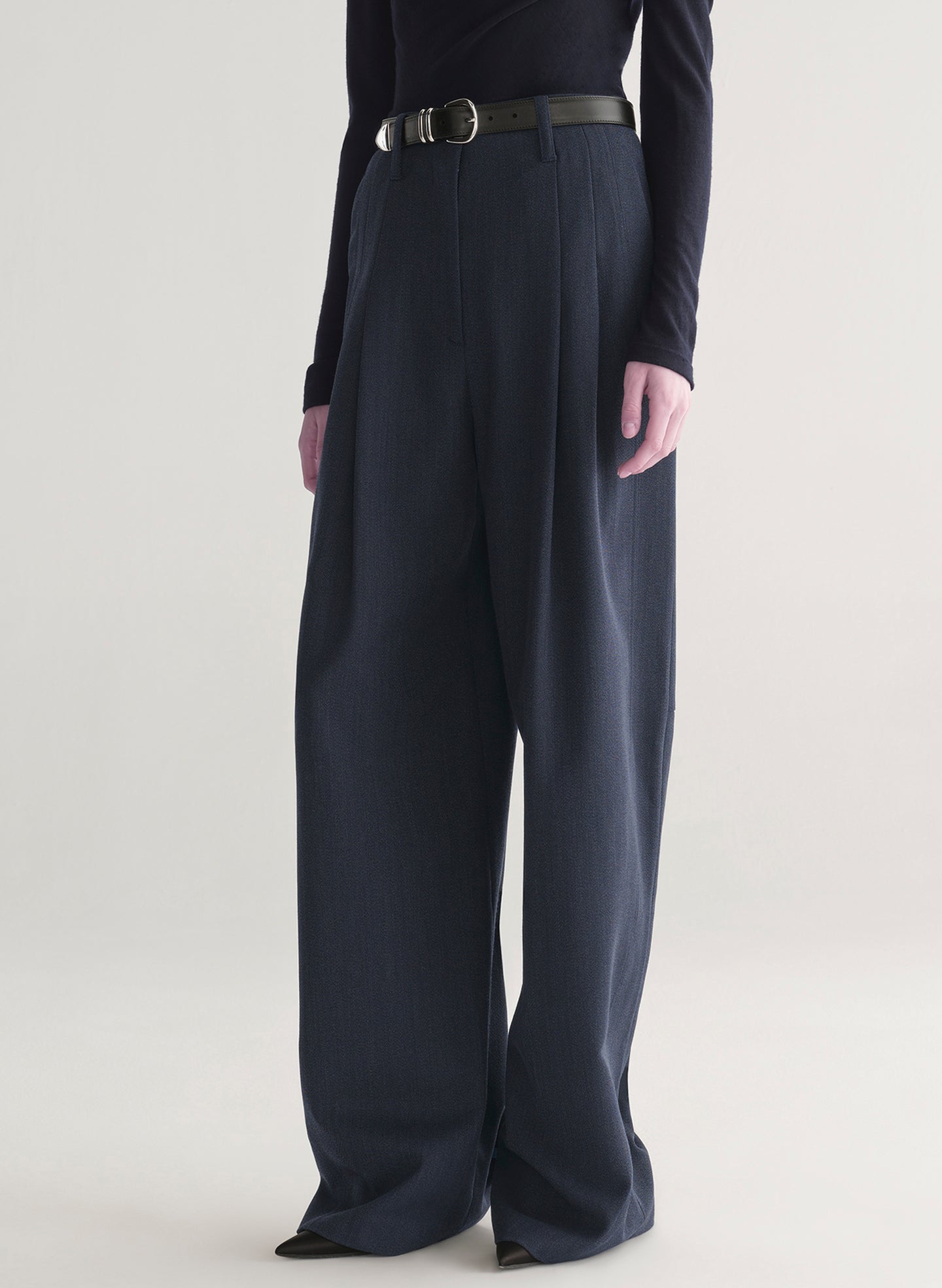 woman wearing navy blue top and and dark blue pants