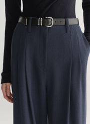 woman wearing navy blue top and and dark blue pants