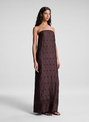 woman wearing dark brown strapless embroidered maxi dress