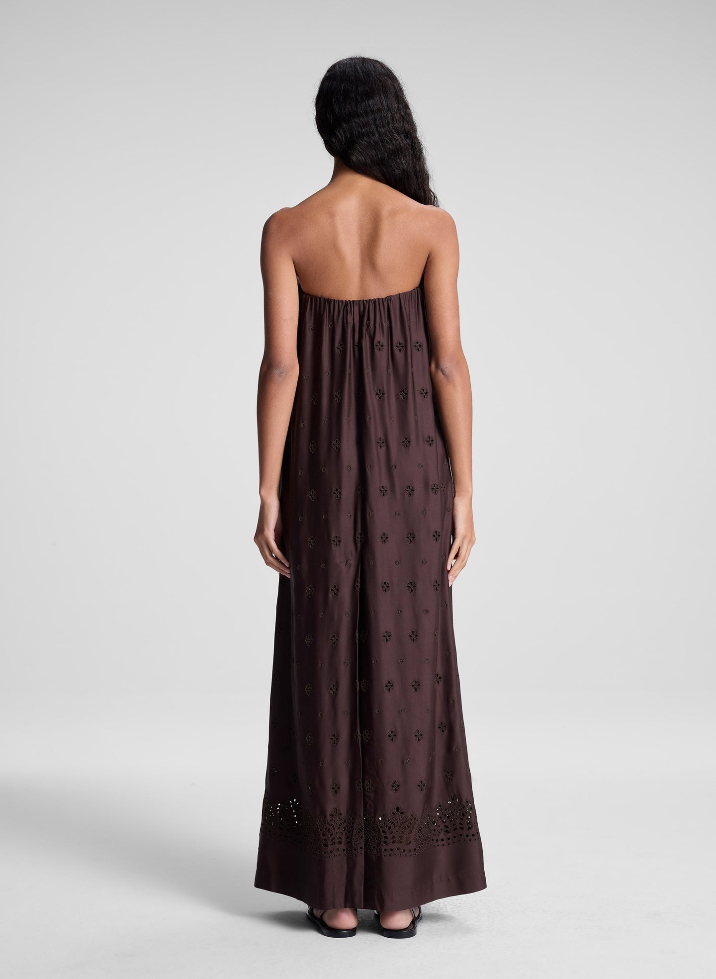 woman wearing dark brown strapless embroidered maxi dress