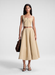 woman wearing beige zip detail tank top and matching set midi skirt