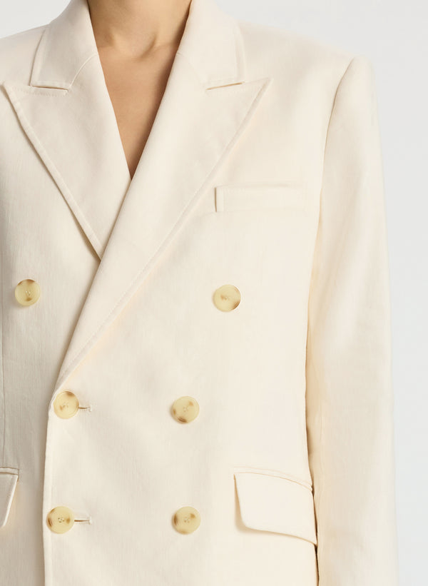 detail view of woman wearing cream shorts suit
