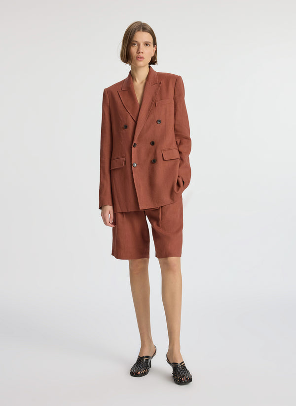 front view of woman wearing brown short suit