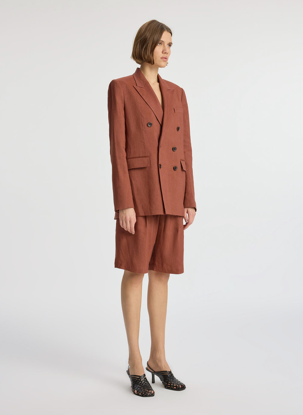 side view of woman wearing brown short suit