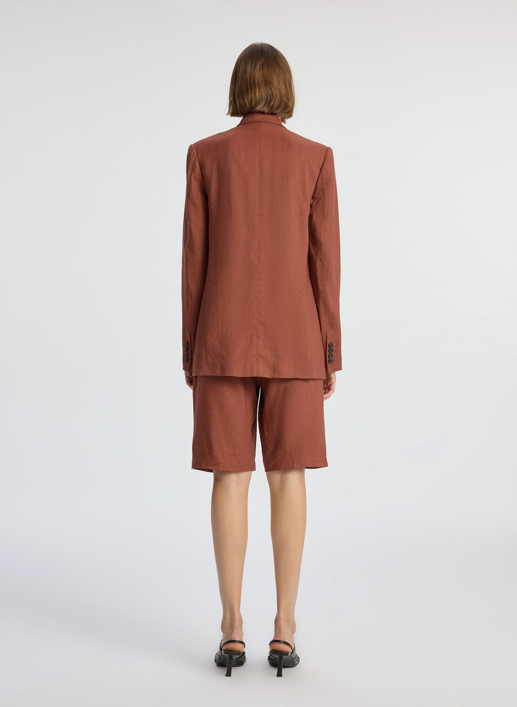 back view of woman wearing brown short suit