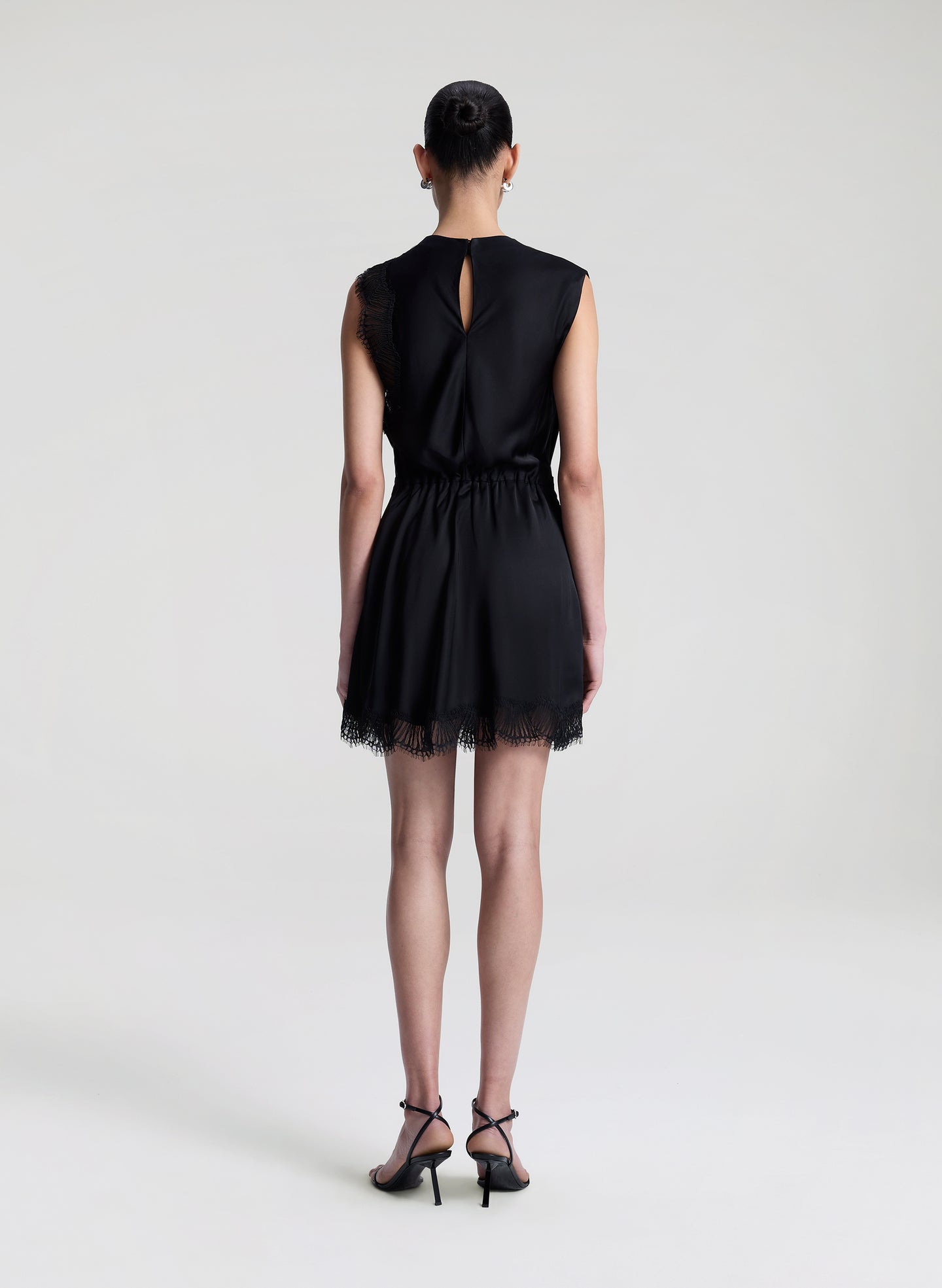 woman wearing black satin and lace mini dress